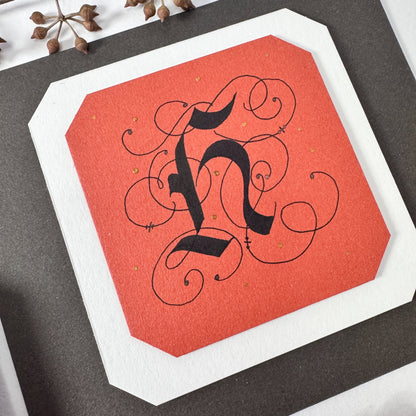 vintage ornate calligraphy hand-lettered onto Materica cardstock paper in the colors Terra Rossa, Gesso, and Pitch Brown